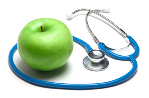 Green apple with stethoscope