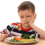 boy and cooked vegetables